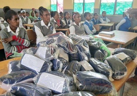 Packs of reusable sanitary pads ready for distribution in a school classroom
