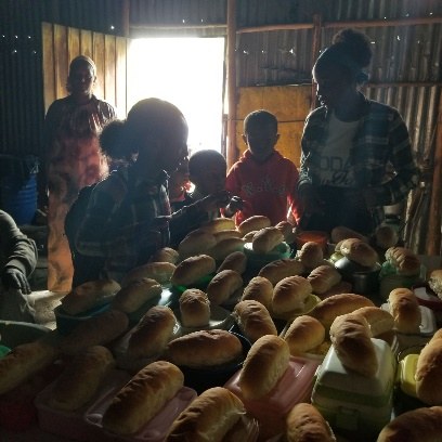 Children gathered as meals are served