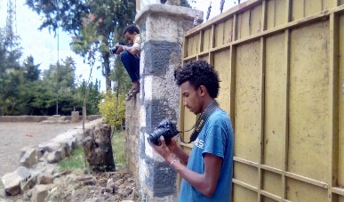 A trainee photographing with a camera