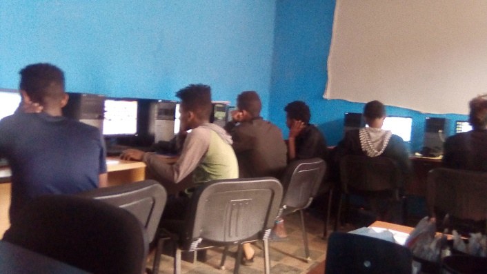Young people learning graphic design on computers